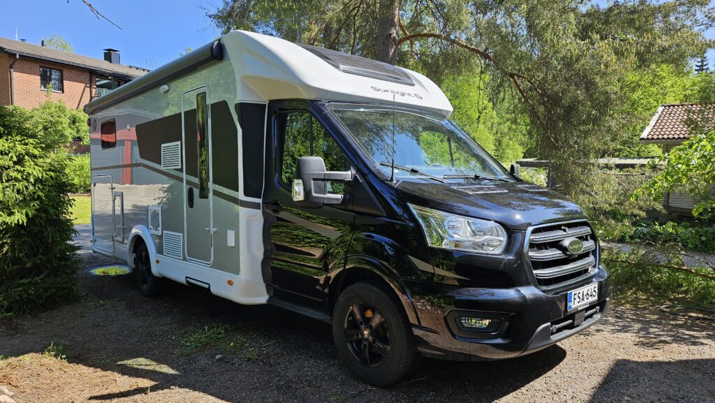 Sunlight T 680 Adventure matkailuauto kesäisessä pihassa